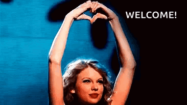 A Woman Is Making A Heart Shape With Her Hands And The Words Welcome Are Behind Her . GIF