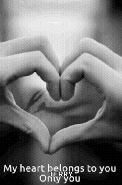 A Woman Is Making A Heart Shape With Her Hands . GIF