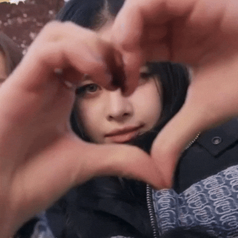 A Woman Is Making A Heart With Her Hands . GIF