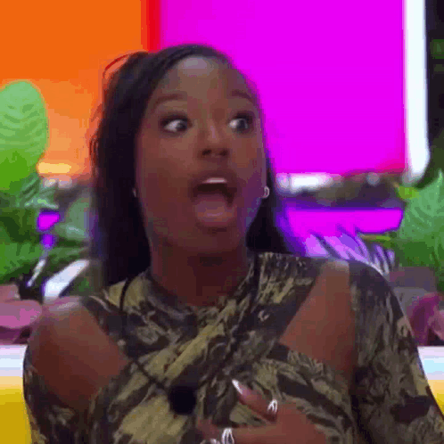A Woman Is Making A Surprised Face With Her Mouth Open And A Surprised Look On Her Face . GIF