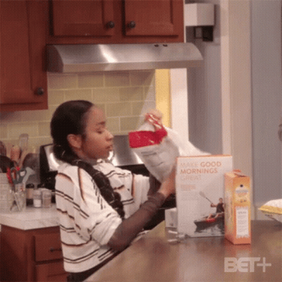 A Woman Is Opening A Box Of Make Good Mornings Cereal GIF