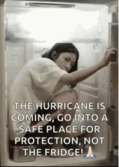 A Woman Is Opening The Door Of A Refrigerator . GIF