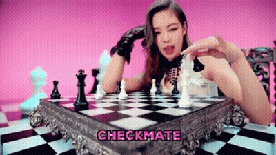 A Woman Is Playing A Game Of Chess With The Words Checkmate Above Her . GIF