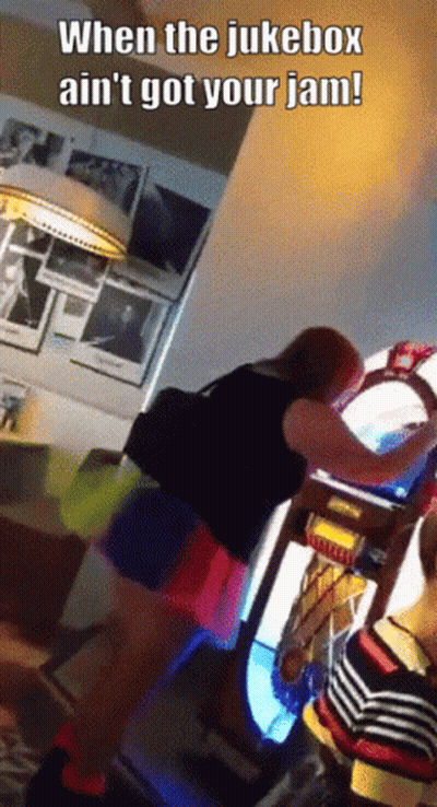 A Woman Is Playing A Jukebox With The Caption When The Jukebox Ain 'T Got Your Jam GIF