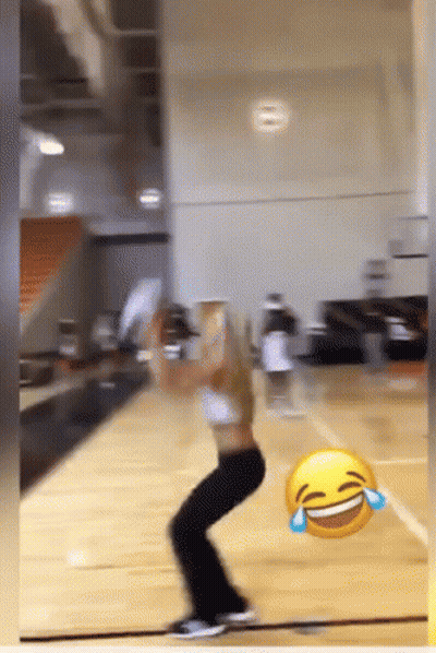 A Woman Is Playing Basketball With A Laughing Face In The Foreground GIF