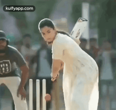 A Woman Is Playing Cricket With A Bat And Ball . GIF