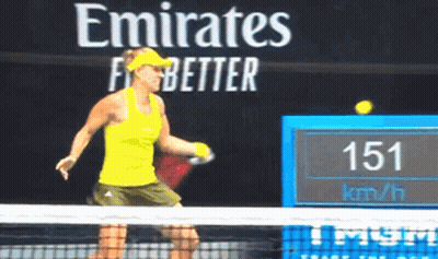 A Woman Is Playing Tennis In Front Of A Sign That Says Emirates Better GIF