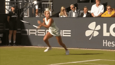 a woman is playing tennis in front of a sign that says lg hes