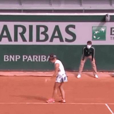 A Woman Is Playing Tennis On A Court In Front Of A Bnp Paribas Sign . GIF