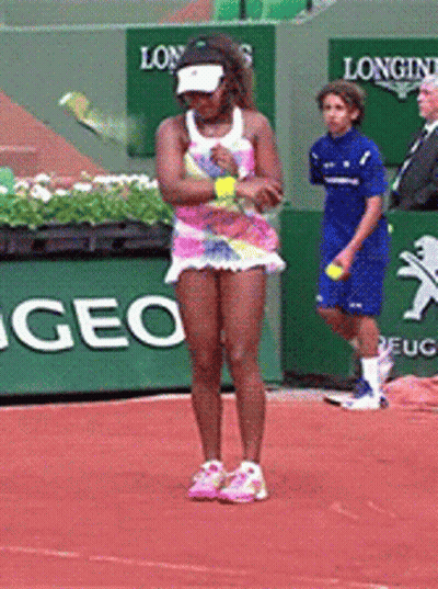 A Woman Is Playing Tennis On A Court With A Longines Sign In The Background GIF