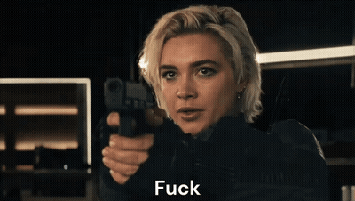 A Woman Is Pointing A Gun At The Camera And Saying " You " . GIF