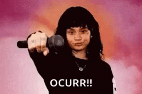 A Woman Is Pointing At The Camera With A Microphone . GIF