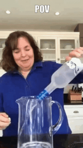 A Woman Is Pouring A Bottle Of Water Into A Pitcher With The Caption Pov GIF