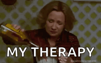 A Woman Is Pouring A Drink Into A Glass With The Words My Therapy Written Below Her GIF