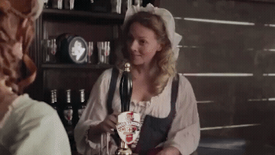 A Woman Is Pouring Beer From A Tap That Has A Shield On It That Says ' Scotch Porter ' GIF