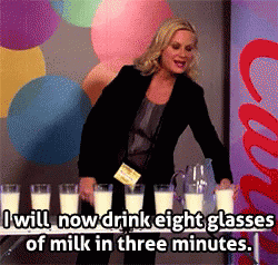A Woman Is Pouring Milk Into Glasses With The Words " I Will Now Drink Eight Glasses Of Milk In Three Minutes " GIF