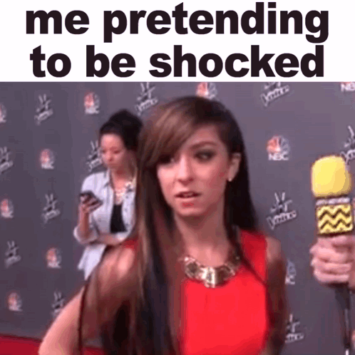 A Woman Is Pretending To Be Shocked While Holding A Microphone . GIF