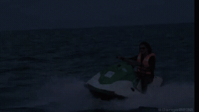 A Woman Is Riding A Jet Ski In The Ocean With The Words On My Way Written Below Her GIF