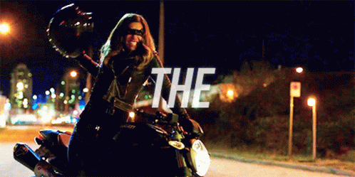 A Woman Is Riding A Motorcycle With The Word The On The Bottom Right GIF