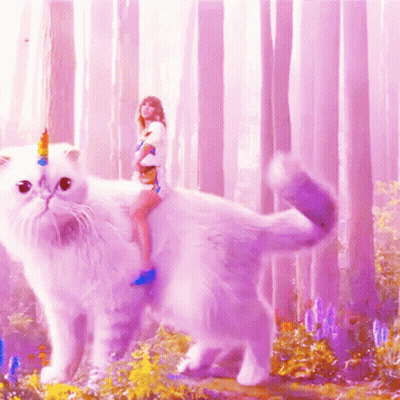 A Woman Is Riding On The Back Of A White Cat With A Unicorn Horn On Its Head GIF