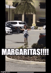 A Woman Is Running In A Parking Lot With A Sign That Says Margaritas GIF