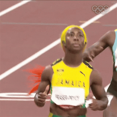 A Woman Is Running On A Track Wearing A Jamaica Jersey GIF