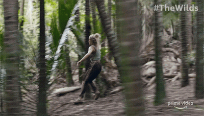 A Woman Is Running Through A Forest In A Prime Video Ad GIF