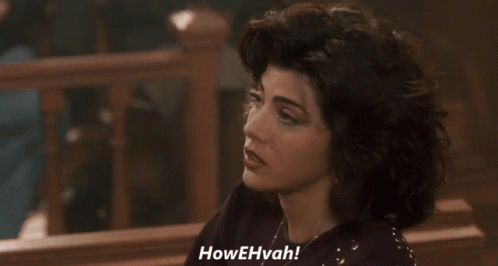 A Woman Is Saying Howehvah In A Dark Room GIF