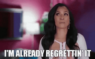 A Woman Is Saying `` I 'M Already Regrettin ' It '' While Standing In A Pink Room . GIF