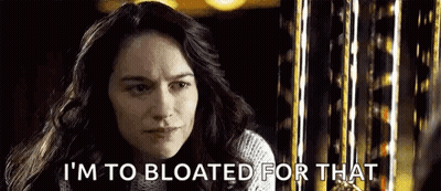 A Woman Is Saying `` I 'M To Bloated For That '' In Front Of A Ferris Wheel . GIF