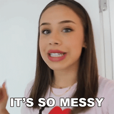 A Woman Is Saying It 'S So Messy While Holding A Red Heart . GIF