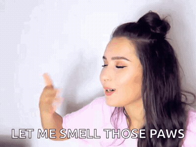 A Woman Is Saying Let Me Smell Those Paws . GIF