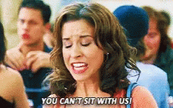 A Woman Is Saying You Can 'T Sit With Us In A Crowd Of People . GIF