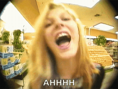 A Woman Is Screaming In A Grocery Store With The Word Ahhhh Above Her GIF