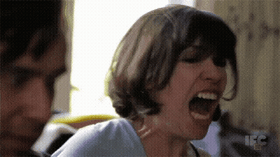 A Woman Is Screaming In Front Of A Man With The Letters Ifc On The Bottom Right GIF
