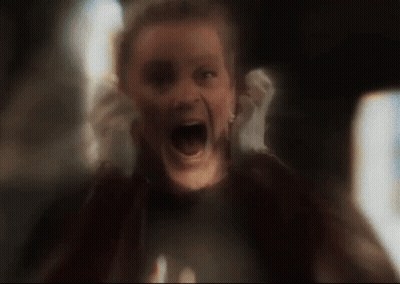 A Woman Is Screaming With Her Mouth Wide Open In A Blurry Photo . GIF