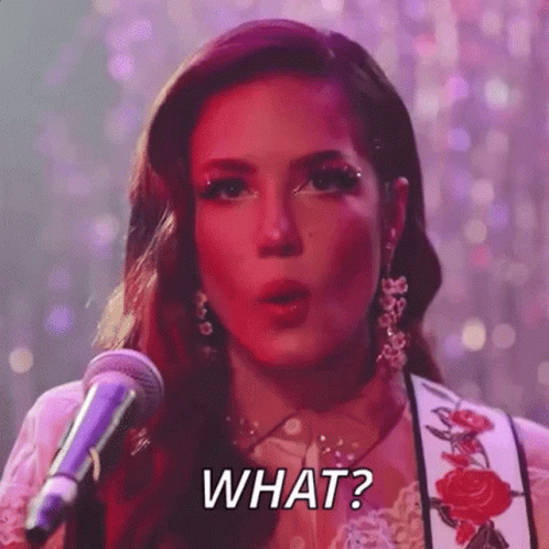 A Woman Is Singing Into A Microphone And Saying `` What ? '' . GIF
