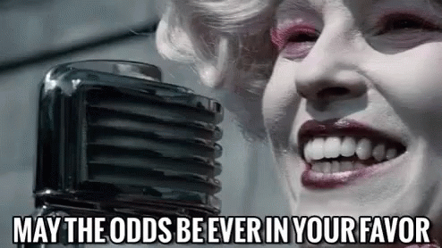 A Woman Is Singing Into A Microphone With The Words `` May The Odds Be Ever In Your Favor '' Written Below Her . GIF