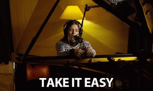 A Woman Is Singing Into A Microphone With The Words Take It Easy Written Below Her GIF