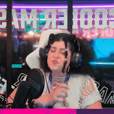 A Woman Is Singing Into A Rode Microphone In Front Of A Sign That Says Game 100 GIF