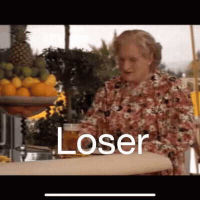 A Woman Is Sitting At A Bar Holding A Glass Of Beer And The Word Loser Is Written On The Screen . GIF