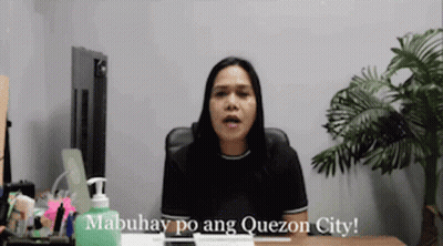 A Woman Is Sitting At A Desk With A Bottle Of Hand Sanitizer In Front Of Her And Says Mabuhay Po Ang Quezon City GIF