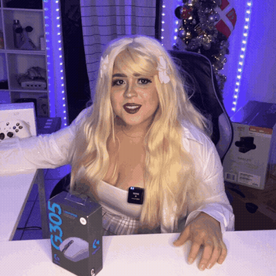 A Woman Is Sitting At A Desk With A Box That Says G305 On It GIF