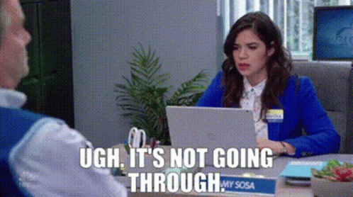 A Woman Is Sitting At A Desk With A Laptop And A Man Is Talking To Her . GIF