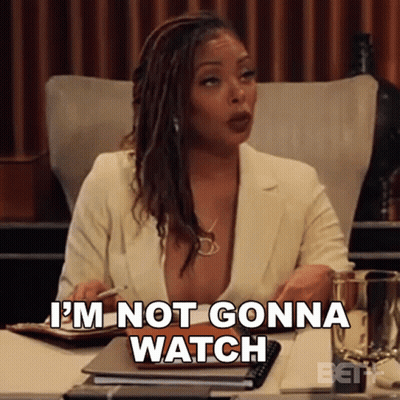 A Woman Is Sitting At A Desk With A Pen In Her Hand And Says I 'M Not Gonna Watch . GIF