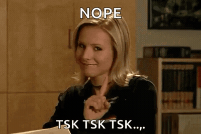 A Woman Is Sitting At A Desk With A Pen In Her Hand . GIF