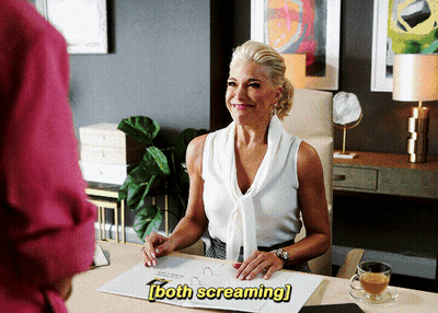 A Woman Is Sitting At A Desk With The Words Both Screaming Written Above Her GIF