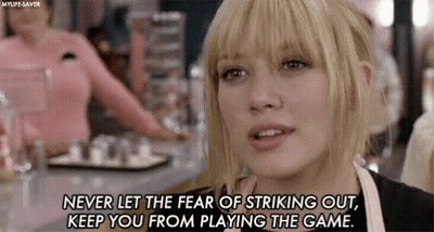 A Woman Is Sitting At A Table In A Restaurant With A Quote On Her Face . GIF