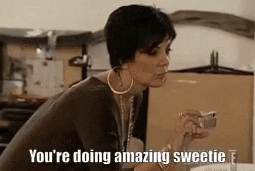 A Woman Is Sitting At A Table Smoking A Cigarette And Holding A Cup Of Coffee . GIF