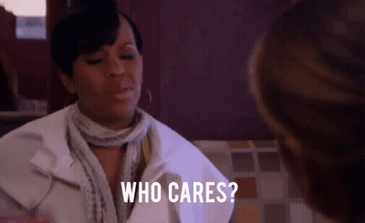 A Woman Is Sitting At A Table Talking To Another Woman And Asking Who Cares . GIF